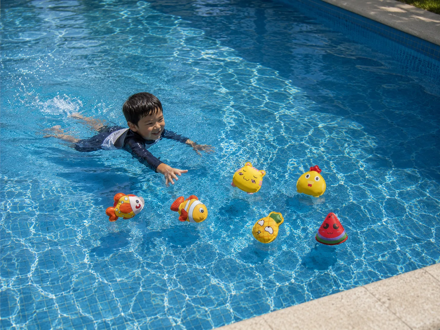 Floating neoprene pool toys with a child swimming nearby