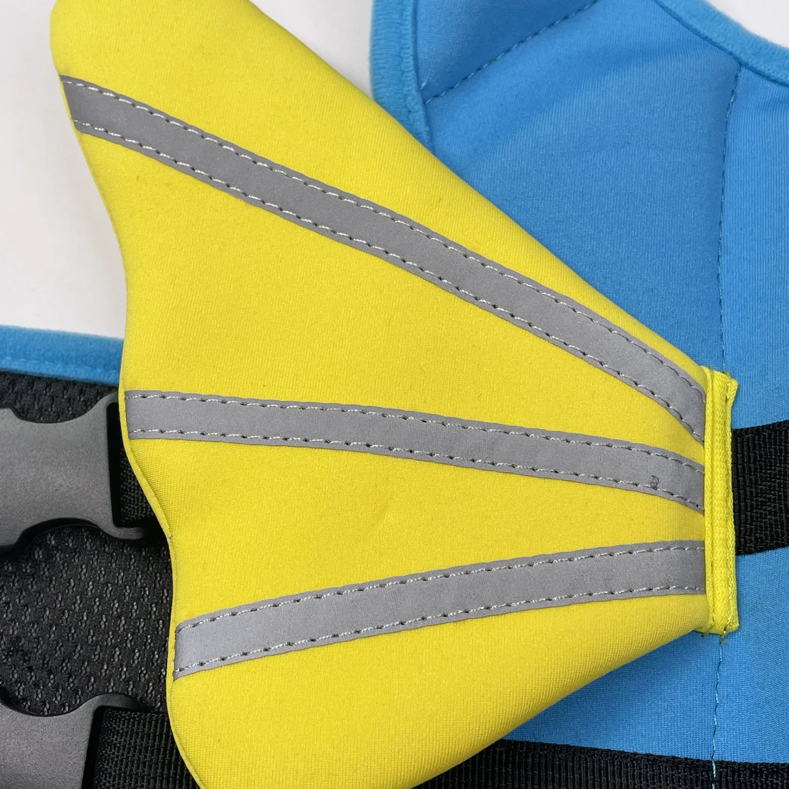 Reflective strip detail on yellow fin dog life jacket