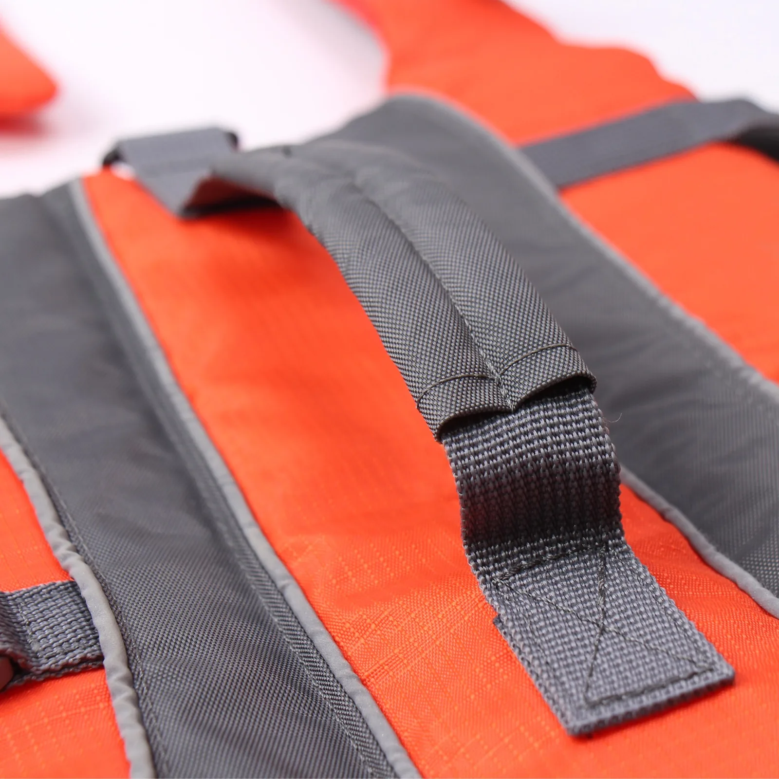 Reinforced rescue handle detail on orange dog life jacket