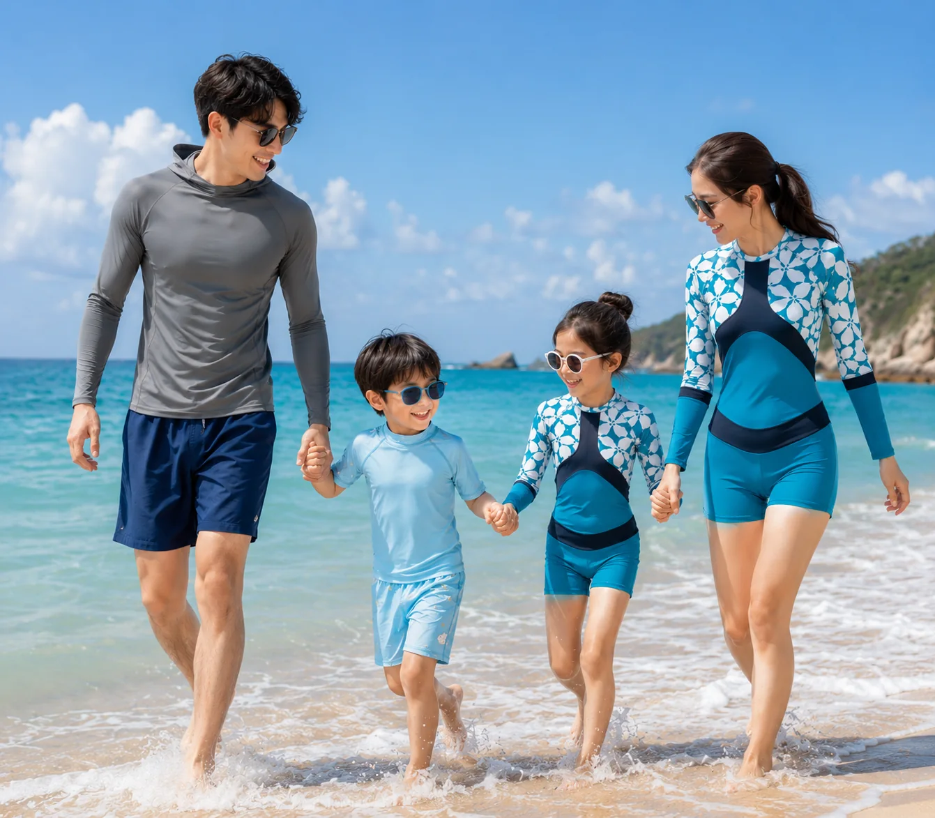 Family wearing rash guards and UV swimwear at the beach